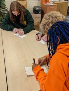 Isabelle, Tom and Miya write their cards